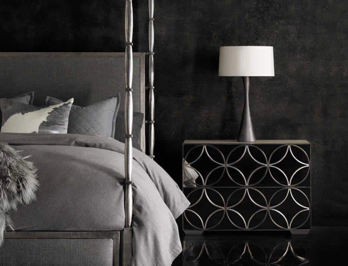 Contemporary dark grey bedroom setup featuring a metallic canopy bed frame and decorative nightstand available at Direct Interiors in Welland.